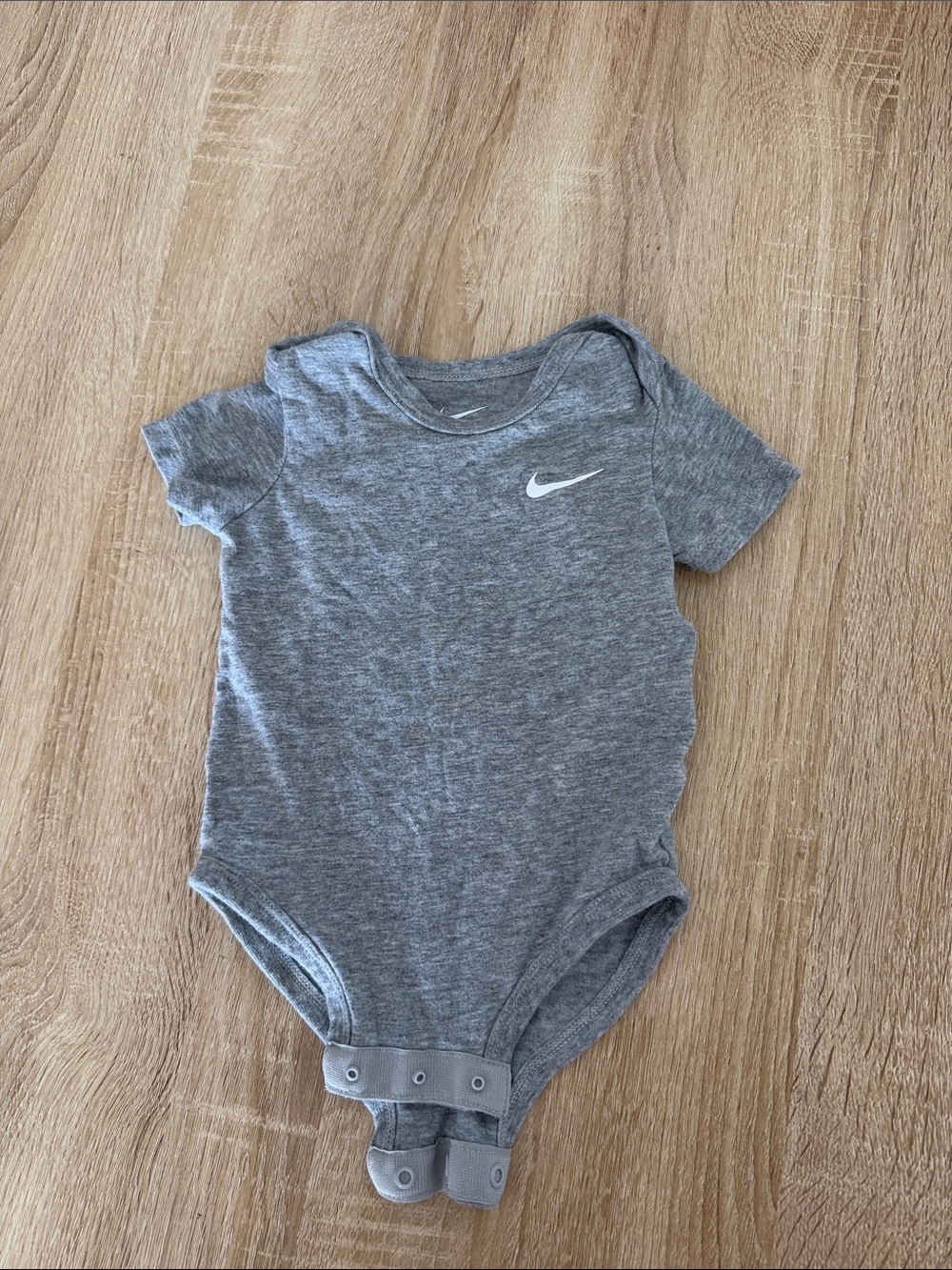 Nike Heather Gray Infant Bodysuit with White Swoosh